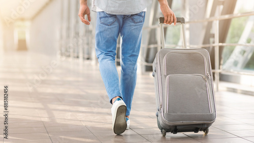 Time To Flight. Unrecognizable Man Walking With Suitcase In Airport, Going To Boarding Gate, Cropped Image, Rear View