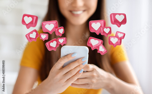 A close-up photo of a young woman smiling as she uses her smartphone. Surrounding her are numerous animated heart icons, symbolizing social media likes and engagement. photo