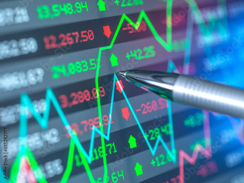 Pen with stock market data on screen