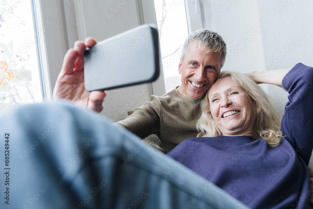Smiling senior couple taking selfie at home Smiling senior couple taking selfie at home