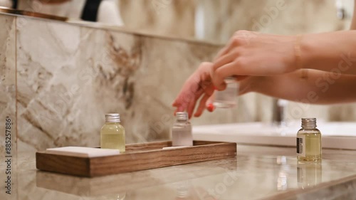Bathroom cleaning. Young chambermaid is in hotel room.