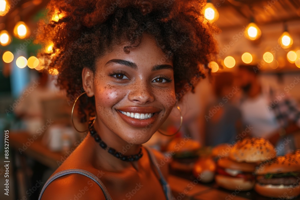 Woman smiling with burgers in a restaurant Woman smiling with burgers in a restaurant