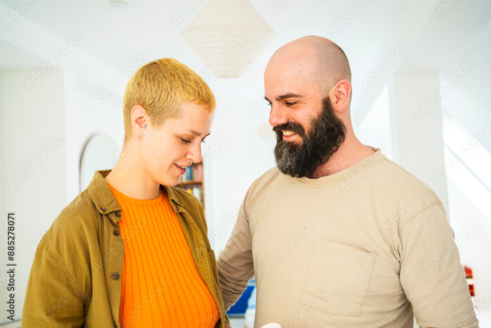 Smiling bearded man with blond woman at home Smiling bearded man with blond woman at home