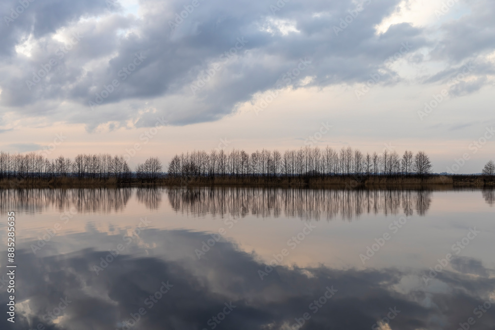 a beautiful reflection of the sky and clouds in the lake at sunset a beautiful reflection of the sky and clouds in the lake at sunset