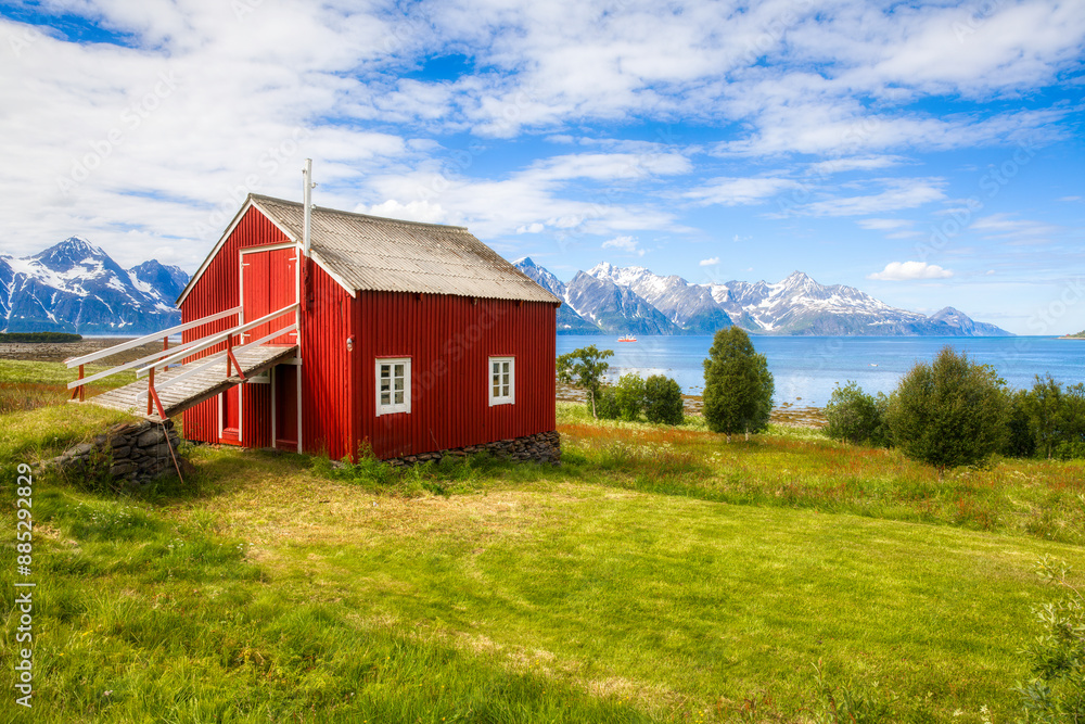 Old Barn near Skittehollet in Lyngenfjord, with the Famous Lyngen Alps Mountain Range, in the Northern Part of Norway Old Barn near Skittehollet in Lyngenfjord, with the Famous Lyngen Alps Mountain Range, in the Northern Part of Norway