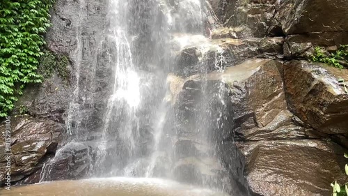 Stream waterfall on rocks in the forest. Waterfall stream on rocks. Beautiful waterfall stream. Waterfall stream in forest.