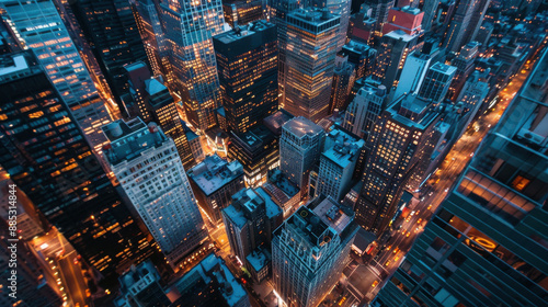 A rooftop view of a large city at night, with glowing buildings and busy streets below © Chatchanan