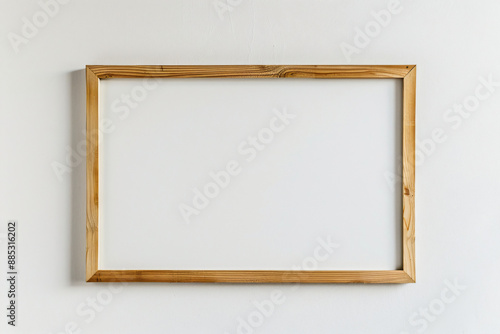 A simple wooden frame mockup on a white background, an empty blank poster template with a thin light wood border for artwork or picture display presentation design template. A top view.