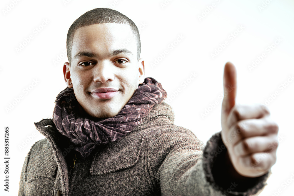 Friendly man giving thumbs-up, smiling confidently Friendly man giving thumbs-up, smiling confidently
