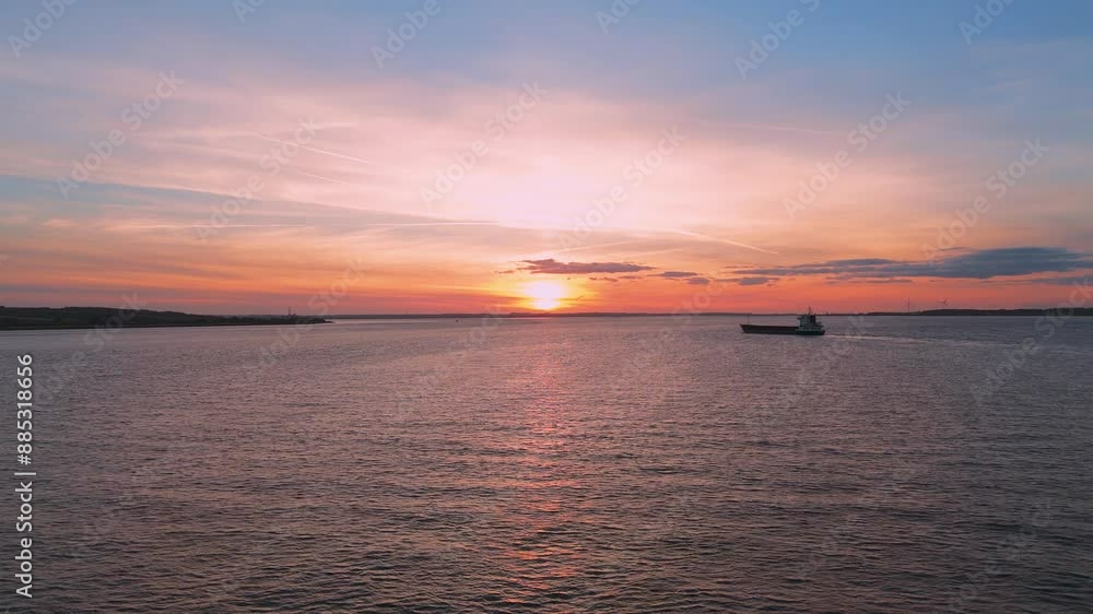 Amidst the golden hour's allure, an aerial drone unveils a barge's tranquil journey beneath Humber Bridge at sunset. Amidst the golden hour's allure, an aerial drone unveils a barge's tranquil journey beneath Humber Bridge at sunset.