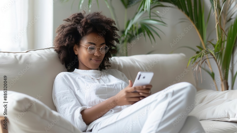 Woman scrolling through her phone on a chaise lounge, chic living room, casual and relaxed Woman scrolling through her phone on a chaise lounge, chic living room, casual and relaxed