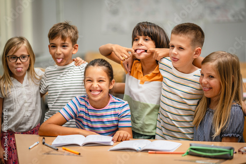 Portrait of group young students climb and have fun in the classroom