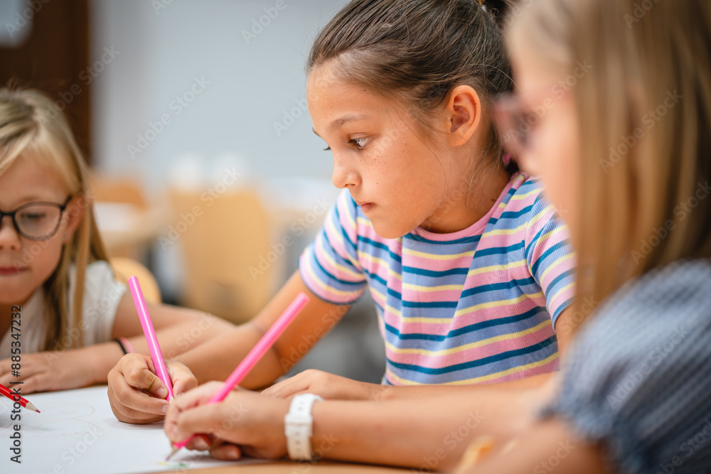 Young girls students paint and draw on class in the classroom