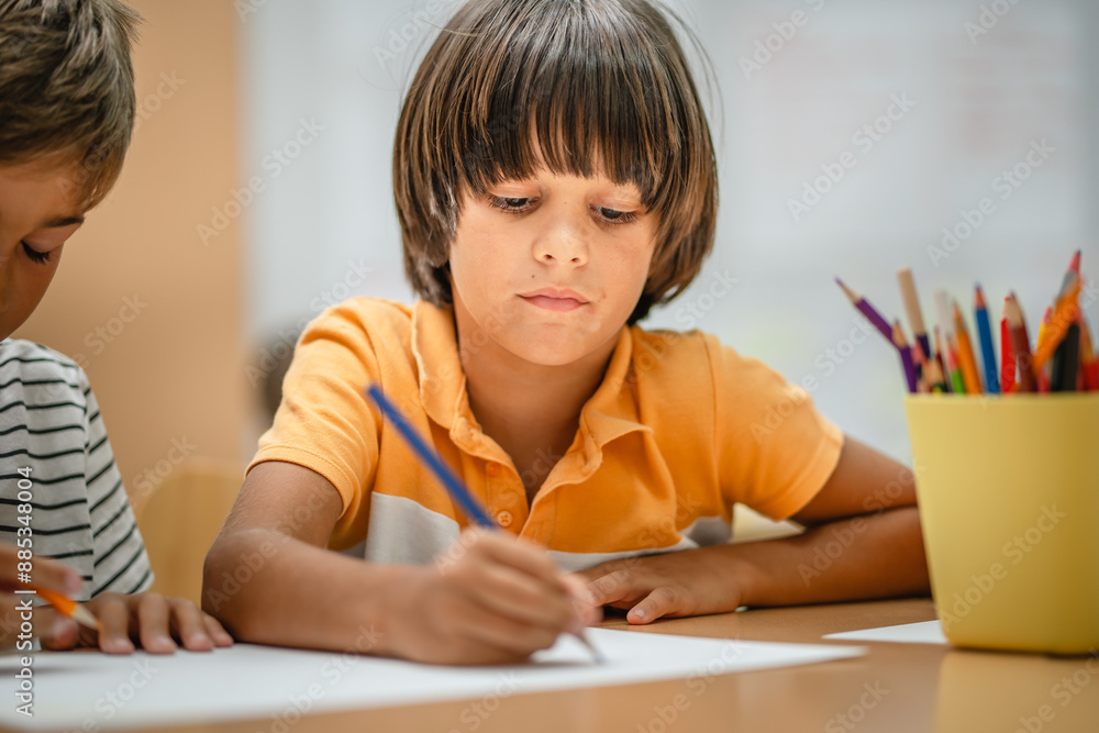 Young boy student paint and draw on class in the classroom Young boy student paint and draw on class in the classroom