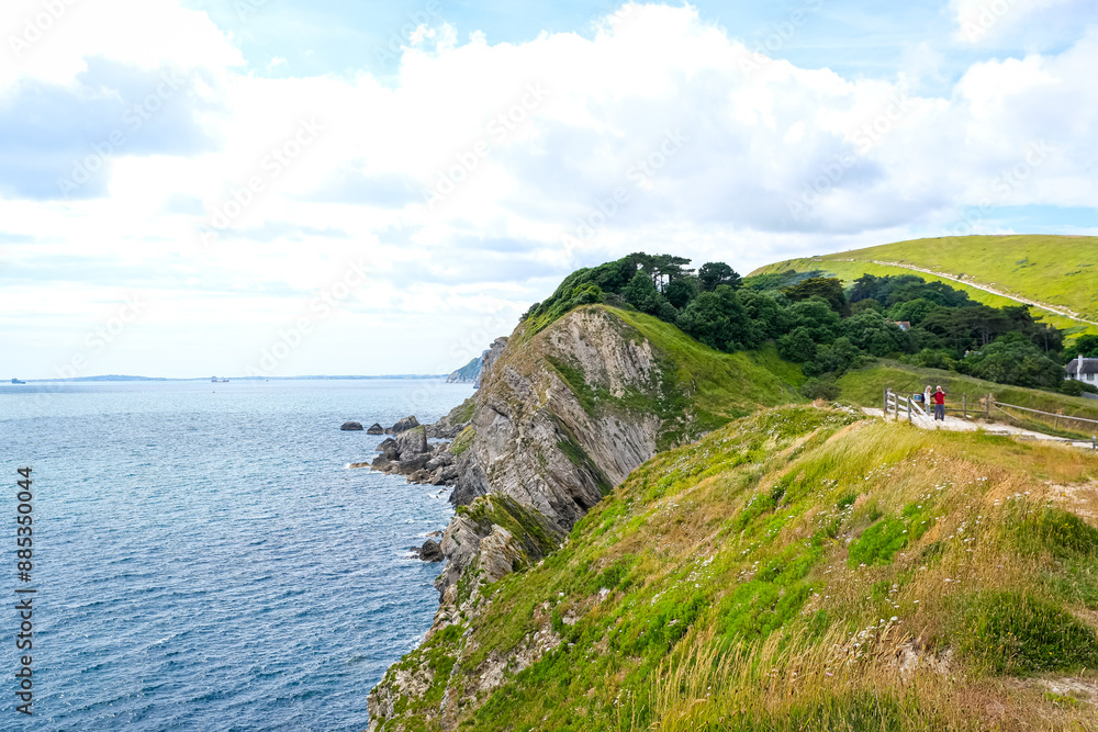 Jurassic coast view in Dorset near Lulworth Cove. Lulworth Cove cliffs view on a way to Durdle Door. The Jurassic Coast is a World Heritage Site on the English Channel coast of southern England.Dorset Jurassic coast view in Dorset near Lulworth Cove. Lulworth Cove cliffs view on a way to Durdle Door. The Jurassic Coast is a World Heritage Site on the English Channel coast of southern England.Dorset