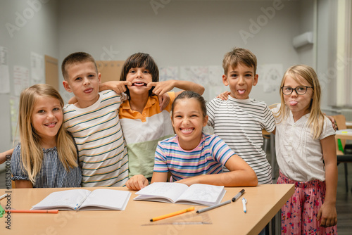 Portrait of group young students climb and have fun in the classroom