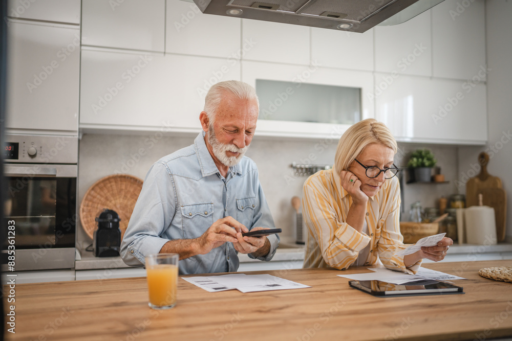 Senior man have contactless payment and mature woman read invoice Senior man have contactless payment and mature woman read invoice