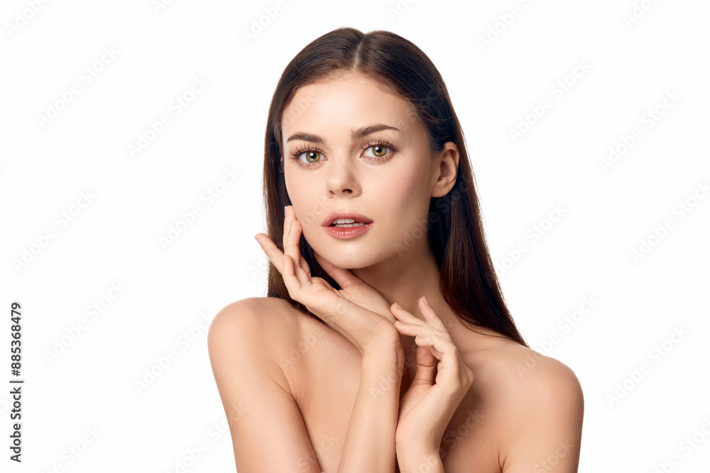Beautiful young woman posing with her hands on her face against a white background Beautiful young woman posing with her hands on her face against a white background
