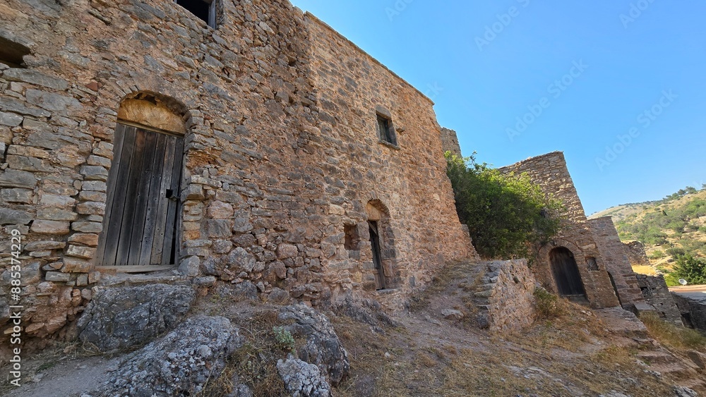 Captivating scene from Anavatos on Chios Island, Greece, featuring unique stone houses and a tree emerging amidst the historic architecture. Captivating scene from Anavatos on Chios Island, Greece, featuring unique stone houses and a tree emerging amidst the historic architecture.