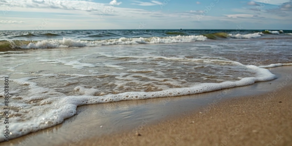 Close-up view of gentle sea waves rolling onto a sandy beach, soft, wave, sea, beach, sand, close-up, background, tranquil
