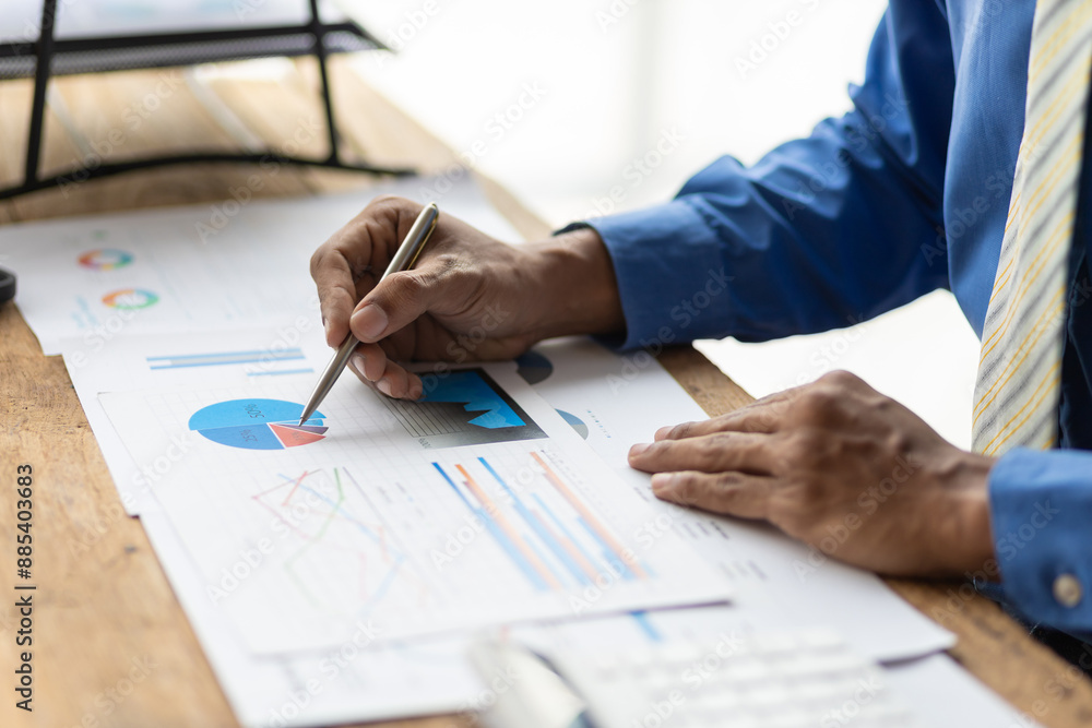 Businessman working inspecting documents is analyzing financial statistics data, Analysis business and investment charts, accounting finance. Accounting income and expense, planning financial budget. Businessman working inspecting documents is analyzing financial statistics data, Analysis business and investment charts, accounting finance. Accounting income and expense, planning financial budget.