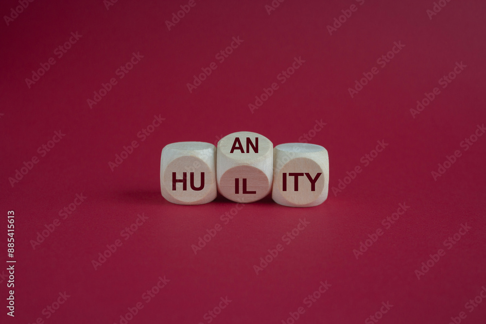 Humility vs humanity symbol. Turned a cube and changed the word 'humility' to 'humanity'. Beautiful red background. Business and humility vs humanity concept Humility vs humanity symbol. Turned a cube and changed the word 'humility' to 'humanity'. Beautiful red background. Business and humility vs humanity concept