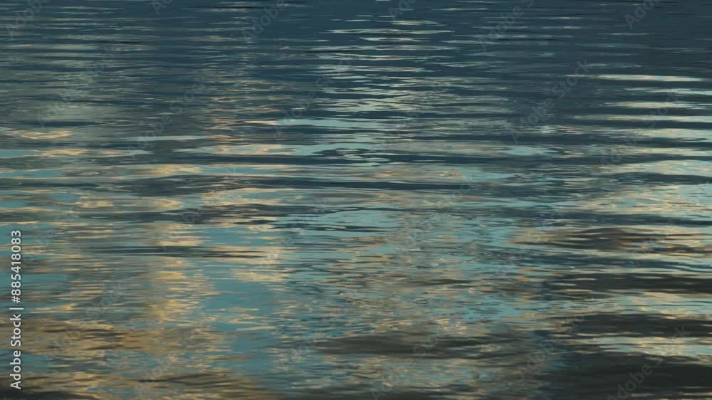 The image of waves on the surface of the water, a beautiful background at dusk at sunset. Environmental problems, lack of drinking water, climate change, drought, global warming. The image of waves on the surface of the water, a beautiful background at dusk at sunset. Environmental problems, lack of drinking water, climate change, drought, global warming.
