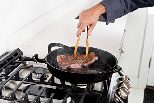 Quadro em tela Cooking a steak on a skillet