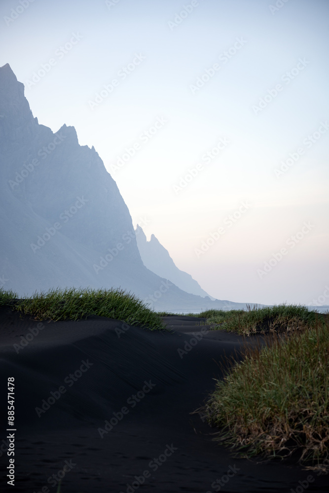 Stunning view of Vestrahorn at sunset with some black sand dunes in the foreground. Vestrahorn is an impressive 454 metres tall mountain. Iceland.