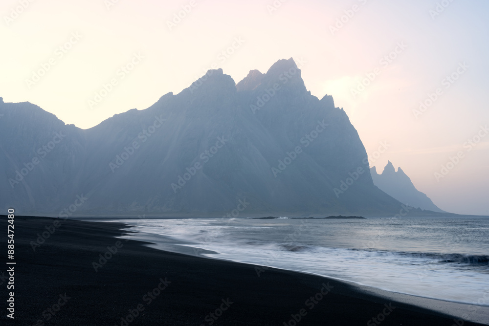 Stunning view of Vestrahorn at sunset with a beautiful black sand beach in the foreground. Vestrahorn is an impressive 454 metres tall mountain. Iceland.