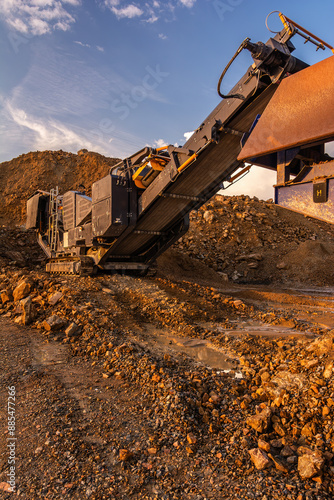 Heavy and mobile machinery in a quarry to transform stone into construction material