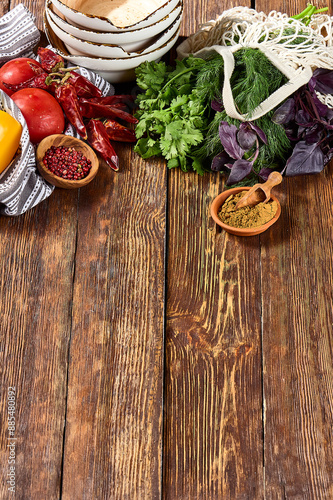 Rustic Wooden Table Displaying Fresh Vegetables, Colorful Spices, and Herbs