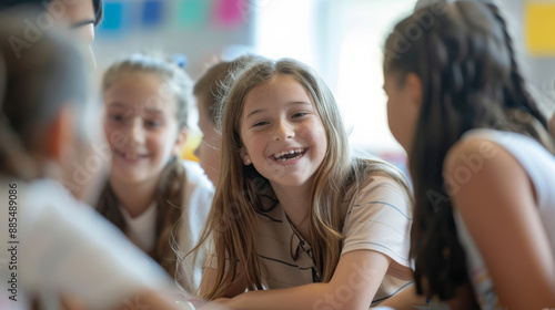 A group of smiling children engaging in conversation in a bright, colorful classroom.