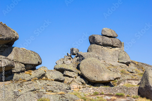 photo background of piles and pyramids of stones on a large stone hill, near the village and monastery in Monsanto, Portugal