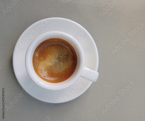 White cup of coffee on the grey background
