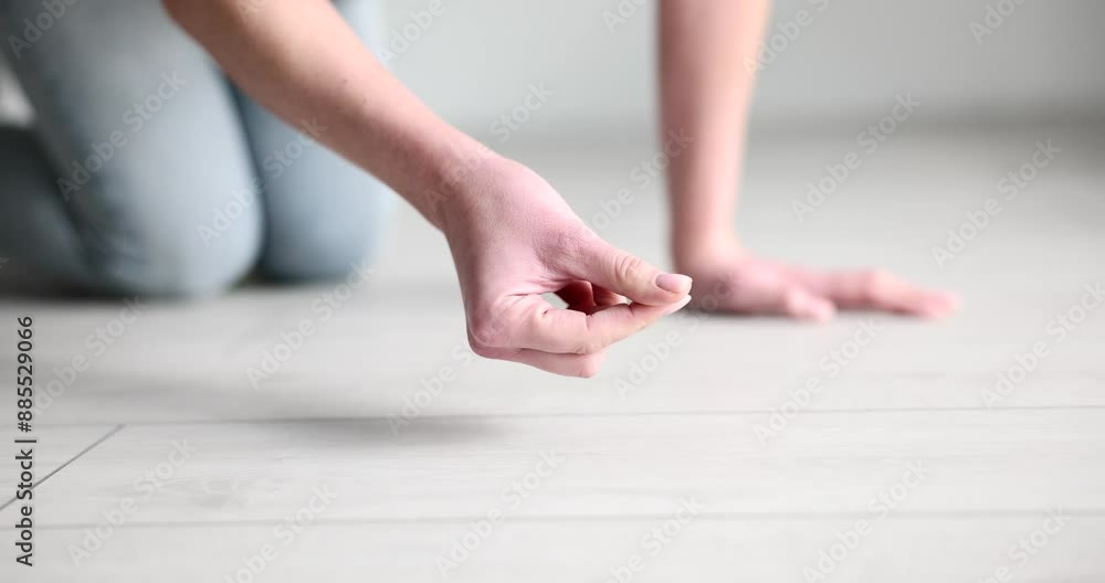 Housewife collects dust on laminate floor with finger. Woman swipes finger on flooring trying to check need for cleaning apartment slow motion Housewife collects dust on laminate floor with finger. Woman swipes finger on flooring trying to check need for cleaning apartment slow motion