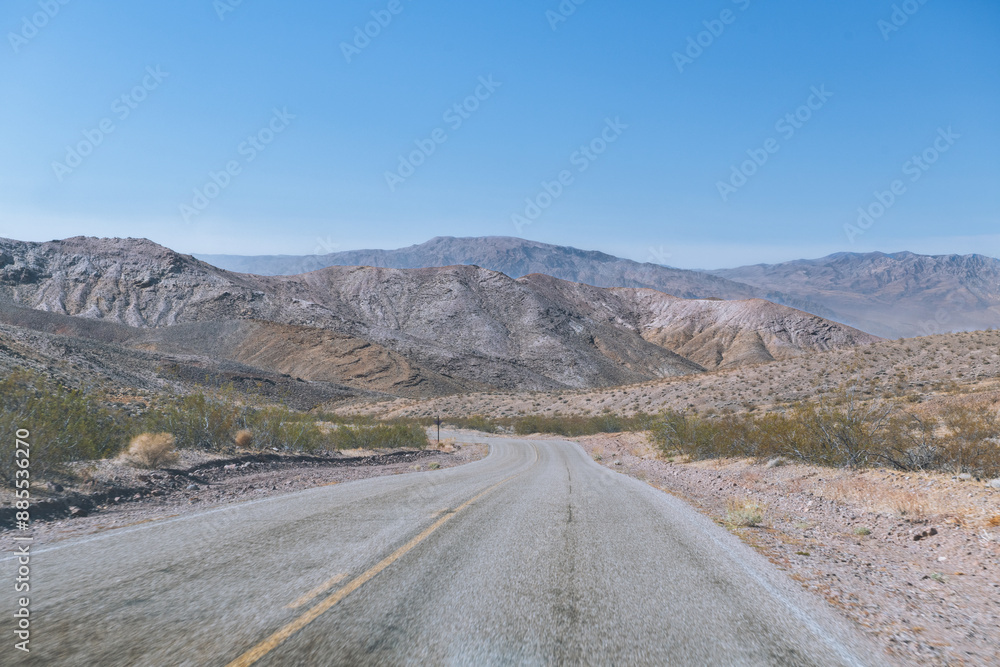 A road with a yellow line down the middle A road with a yellow line down the middle