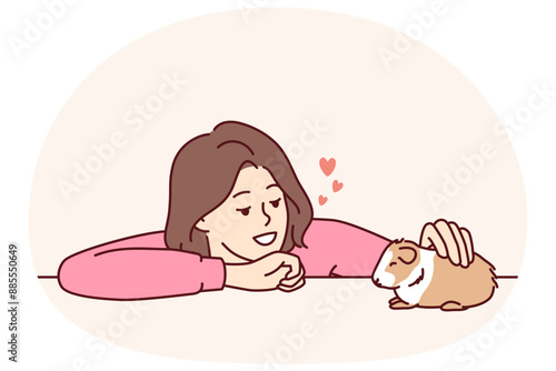 Caring woman pets guinea pig or hamster enjoying companionship of cute pet given to by parents or boyfriend. Young kind girl takes care of guinea pig doing grooming and admiring friendly pet