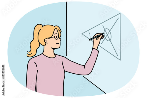 Girl student of mathematical school writes formulas on blackboard, solving complex equations at algebra olympiad. Young woman is fond of mathematics and study at university or college for education