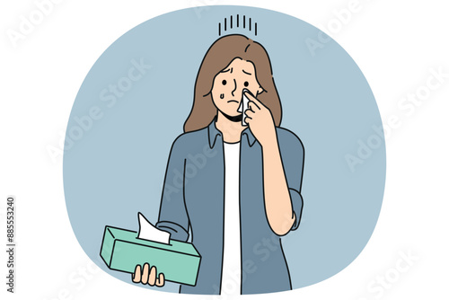 Crying woman wipes tears with paper napkins, experiencing stress and psychological suffering after breaking up with boyfriend. Crying girl holding box of disposable towels needing help of psychologist