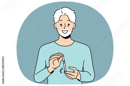 Elderly man uses glucometer to measure level insulin in blood and smiles, rejoicing at easing diabetes. Gray-haired grandfather with glucometer recommends fighting diabetes and taking care of health