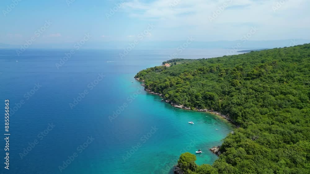 A serene and picturesque beach with turquoise waters, captured by drone on the island of Krk near Glavotok. A boat can be seen drifting on the crystal-clear water, creating a perfect haven for relax A serene and picturesque beach with turquoise waters, captured by drone on the island of Krk near Glavotok. A boat can be seen drifting on the crystal-clear water, creating a perfect haven for relax