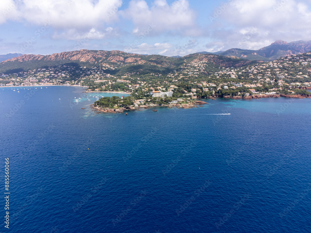 Fototapeta premium Panoramic view from above on blue Mediterranean dea, sandy beach of Agay town, summer vacation destination near Esterel mountains, French Riviera, Provence. France