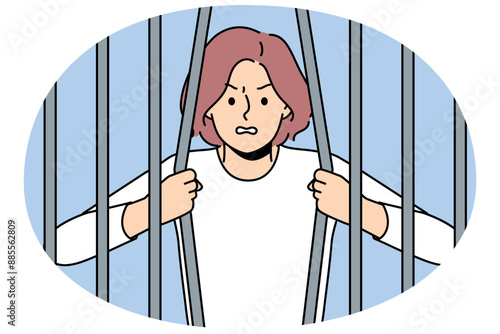 Woman prisoner breaks bars wanting to be released from captivity, for concept fight against discrimination and restrictions. Girl prisoner trying to escape from prison to avoid punishment for crimes