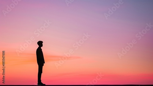 Silhouette of a Person Standing Against a Vibrant Sunset Sky