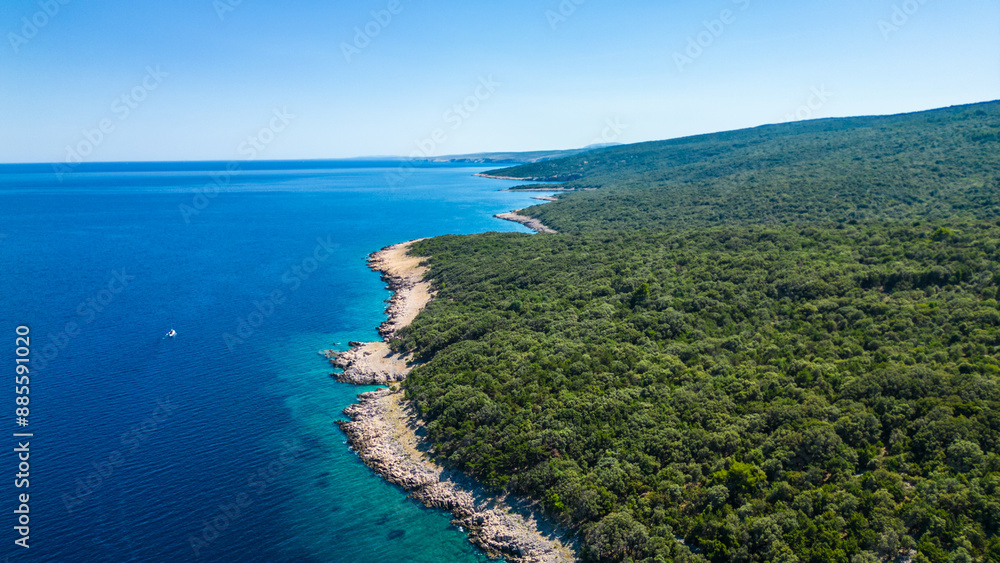 An aerial view of the Blue Lagoon at Plaža Krušćica and Tarej Beach on the island of Cres, showcasing their fantastic turquoise waters and surrounding islands. Boats dot the serene lagoon An aerial view of the Blue Lagoon at Plaža Krušćica and Tarej Beach on the island of Cres, showcasing their fantastic turquoise waters and surrounding islands. Boats dot the serene lagoon