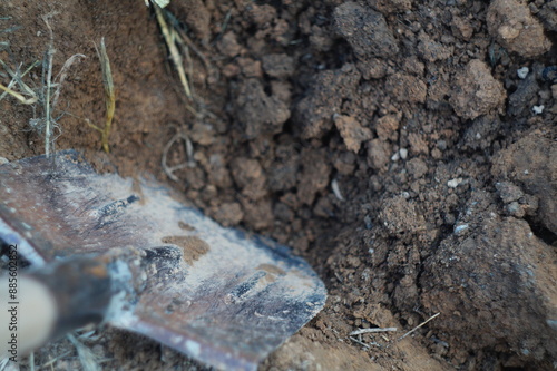 Photography An excavated area of land by hand with a shovel containing large pieces of soil