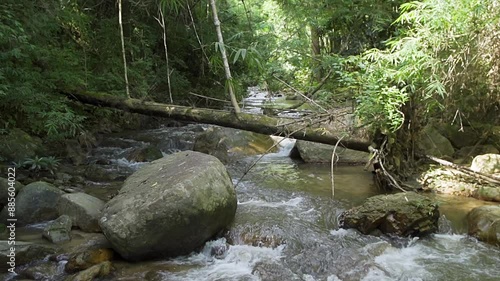 Beautiful stream in tropical forest in Chae Son National Park, Lampang, Thailand - slow motion