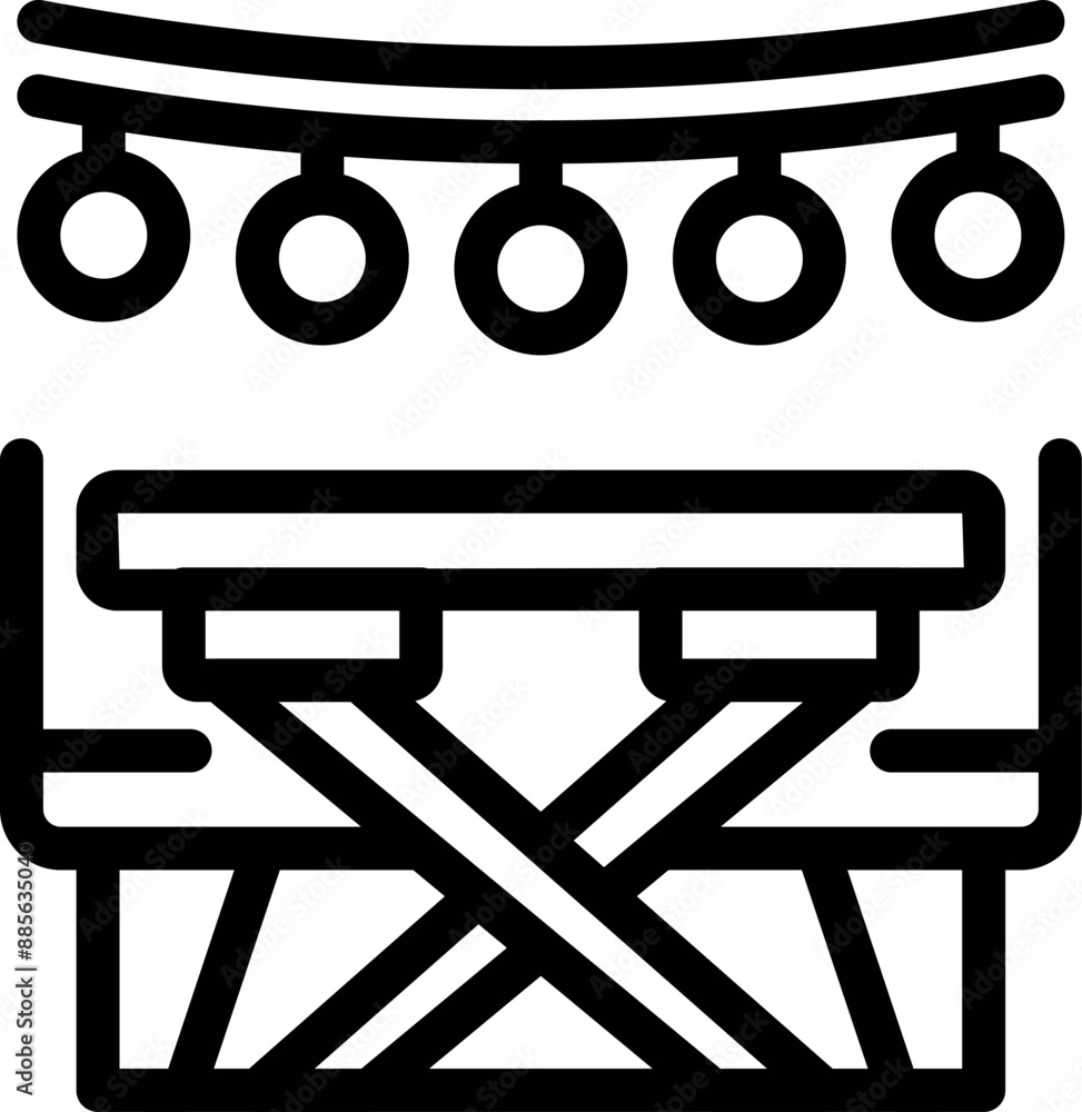 Folding camping table illuminated by string lights for an outdoor evening party