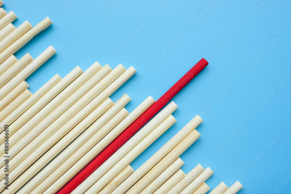 Wooden sticks and red one. Leadership or Uniqueness abstract art. Wooden sticks and red one. Leadership or Uniqueness abstract art.